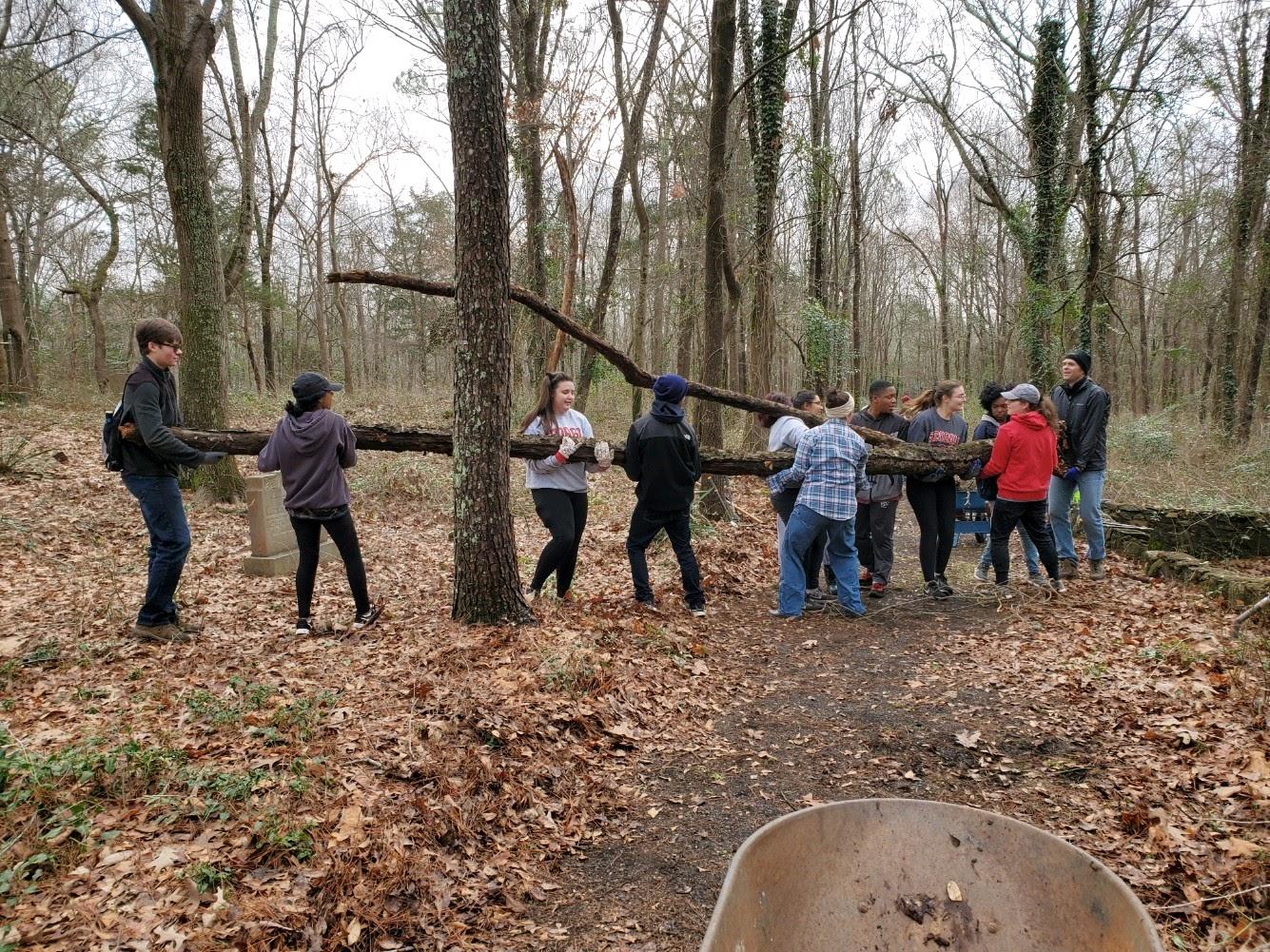 FRC members work together to move a tree at Gospel Pilgrim