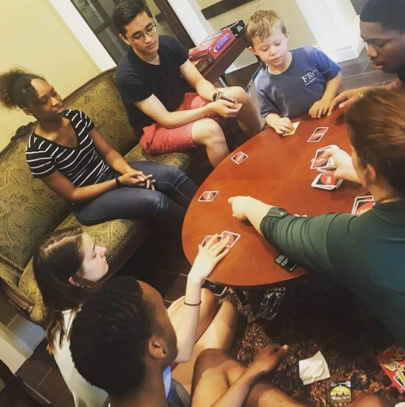 Family game night in Rutherford parlor