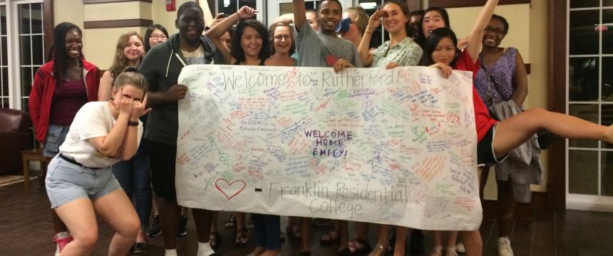 Students holding welcome sign in Rutherford